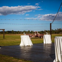 Outdoor cocktail/dance floor with market lights and a vintage truck. That wooden archway is another spot where you can have the ceremony