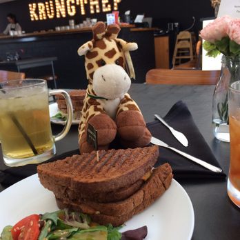 KrungThep Tea Time - Owen the hipster enjoying Satay Satay on pumpernickel bread. - Tea Rooms Near Me - Winter Park, Florida KrungThep Tea Time - Owen the hipster enjoying Satay Satay on pumpernickel bread. - Tea Rooms Near Me - Winter Park, Florida