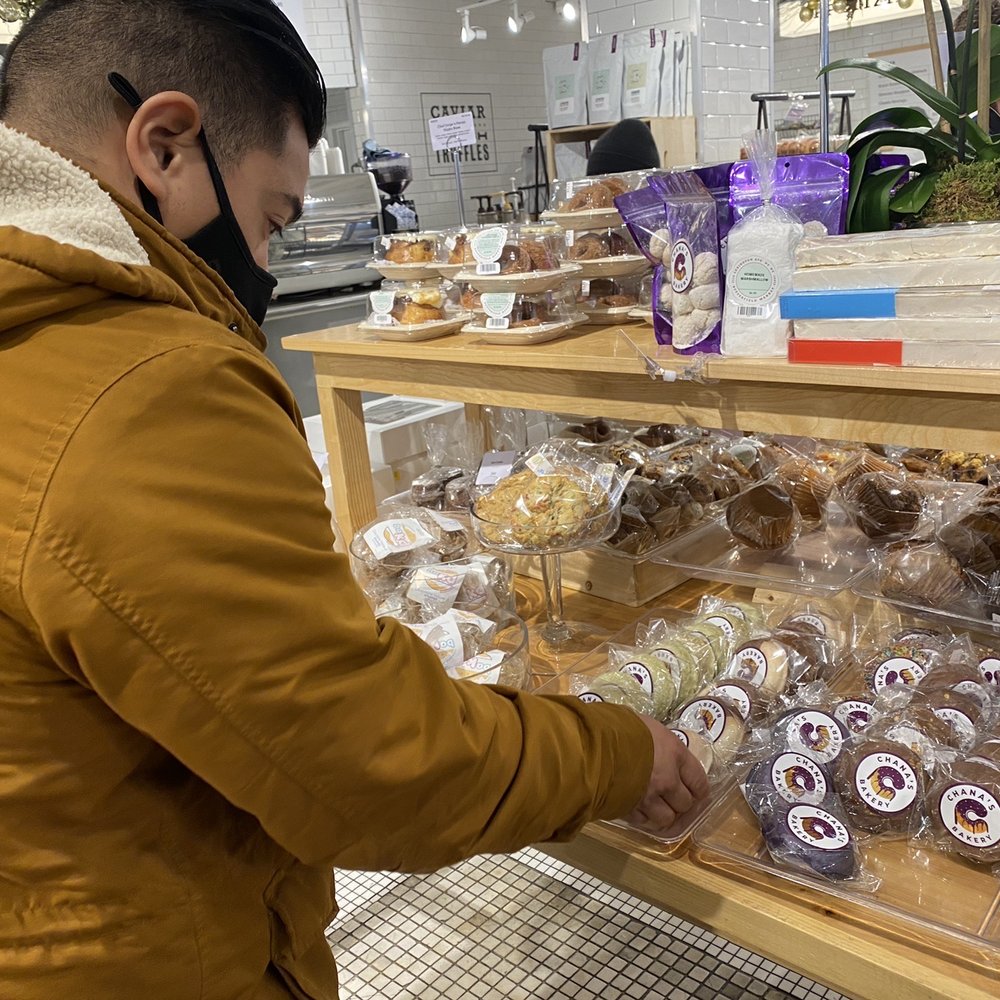 Chana's Bakery - a man selecting pastries - Bakeries Near Me Chana's Bakery - a man selecting pastries - Bakeries Near Me