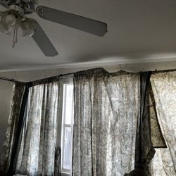 Foxs RV Resort - Broken curtain rods and dusty fan