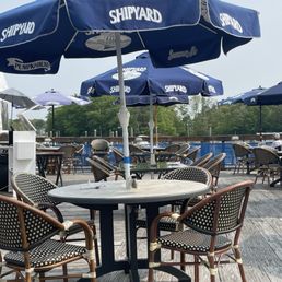 Outdoor seating. Next to the water and beautiful boats.
