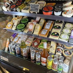 Tartufo - Assortment of cheeses, dips, spreads, meats, and drinks.