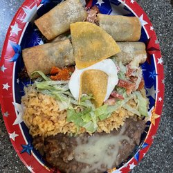 Huele a Tacos - #18 one carnitas enchilada (under lettuce & tomato) and two rolled (fried) tacos with rice and beans.