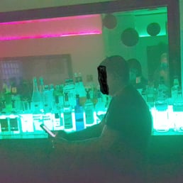 Inattentive bartender playing with his mobile device
