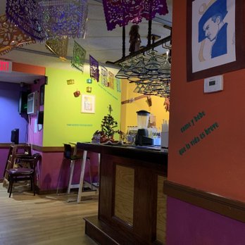 Mezcal - a brightly colored restaurant with tables and chairs - Mexican Near Me - New Haven, Connecticut