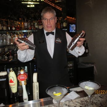 Parlour Bar & Lounge - a bartender holding two bottles of liquor - Lounges Near Me - Las Vegas, Nevada Parlour Bar & Lounge - a bartender holding two bottles of liquor - Lounges Near Me - Las Vegas, Nevada