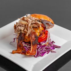 Exotic Burger - Marinated beef patty, roasted pulled pork, rosemary candied bacon, sharp cheddar, caramelized onions, served with shaved potatoes