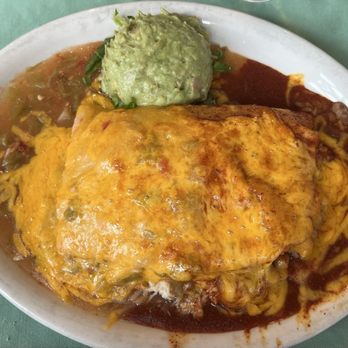 Rancho De Chimayo Restaurante - Stuffed sopaipilla with chicken smothered in cheese with Christmas chile. - New Mexican Cuisine Near Me - Chimayo, New Mexico
