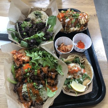 KoJa Kitchen - Back left is Short Rib Bowl Back right is Umami Fries Front left is Beef Bowl Front right braised pork taco - Japanese Near Me - Emeryville, California