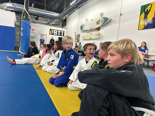 Kids Brazilian Jiu Jitsu - Our Kids Brazilian Jiu Jitsu program focuses on five key factors:
1-The art of Brazilian Jiu-Jitsu
2- Discipline
3- Integrity
4- Inner strength
5- Work Ethic
Brazilian Jiu Jitsu is not easy. It is widely accepted that it is, in fact, the most difficult Martial Art. We challenge each of our children to put in real effort. To push themselves to be the best they can be BOTH on and off the mats. We are heavily involved with the parents and encourage updates on behavior and grades at school. We keep an open line of communication so that we can be a resource for your family. We consider it our HIGHEST Honor that you allow us to teach your children this amazing art.
Key lines of instruction, in addition to learning legitimate self defense techniques, include an anti bullying program. From time to time we will discuss Verbal and Non-Verbal communication skills to show your child how to carry themselves in a manner, that avoids conflict. But if conflict should find them.. they are prepared. We also encourage the defense of others to instill a high level of integrity. In short- bullying is never acceptable. We encourage our students to “Speak up” or “Step up” to defend others against such behavior.
HEALTH and FITNESS:
In the new cyber world we have seen a great increase in childhood obesity. Kids today are more inclined to play online or on an iPad or cell phone than to get outside and exercise. Each of our classes starts with a highly effective cardiovascular workout that increases overall health and wellness in our students. The students are pushed and “Motivated” not only by the host of coaches, but by the other students. We are truly a team.
A BALANCED APPROACH:
As a reward for good effort we will routinely convert an entire class into a “Game class” with indoor soccer, or other Jiu Jitsu related games. We often play dodge-ball or have a special instructor come in to mix it up. We want discipline, and structure but we ALSO WANT FUN!
WHAT DOES BRAZILIAN JIU JITSU LOOK LIKE?
Here is some footage from a high level kids tournament! Enjoy! Kids Brazilian Jiu Jitsu - Our Kids Brazilian Jiu Jitsu program focuses on five key factors:
1-The art of Brazilian Jiu-Jitsu
2- Discipline
3- Integrity
4- Inner strength
5- Work Ethic
Brazilian Jiu Jitsu is not easy. It is widely accepted that it is, in fact, the most difficult Martial Art. We challenge each of our children to put in real effort. To push themselves to be the best they can be BOTH on and off the mats. We are heavily involved with the parents and encourage updates on behavior and grades at school. We keep an open line of communication so that we can be a resource for your family. We consider it our HIGHEST Honor that you allow us to teach your children this amazing art.
Key lines of instruction, in addition to learning legitimate self defense techniques, include an anti bullying program. From time to time we will discuss Verbal and Non-Verbal communication skills to show your child how to carry themselves in a manner, that avoids conflict. But if conflict should find them.. they are prepared. We also encourage the defense of others to instill a high level of integrity. In short- bullying is never acceptable. We encourage our students to “Speak up” or “Step up” to defend others against such behavior.
HEALTH and FITNESS:
In the new cyber world we have seen a great increase in childhood obesity. Kids today are more inclined to play online or on an iPad or cell phone than to get outside and exercise. Each of our classes starts with a highly effective cardiovascular workout that increases overall health and wellness in our students. The students are pushed and “Motivated” not only by the host of coaches, but by the other students. We are truly a team.
A BALANCED APPROACH:
As a reward for good effort we will routinely convert an entire class into a “Game class” with indoor soccer, or other Jiu Jitsu related games. We often play dodge-ball or have a special instructor come in to mix it up. We want discipline, and structure but we ALSO WANT FUN!
WHAT DOES BRAZILIAN JIU JITSU LOOK LIKE?
Here is some footage from a high level kids tournament! Enjoy!