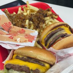 Double double burger and french fries with grilled onions Double double burger and french fries with grilled onions