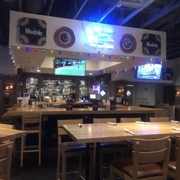a restaurant with tables and televisions