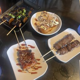 Miso-glazed eggplant, takoyaki, beef skewers, eel skewers Miso-glazed eggplant, takoyaki, beef skewers, eel skewers