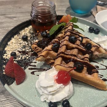 Pancake - Long Beach - Waffles with berries drizzled with chocolate syrup. - Breakfast & Brunch Near Me - Long Beach, California Pancake - Long Beach - Waffles with berries drizzled with chocolate syrup. - Breakfast & Brunch Near Me - Long Beach, California
