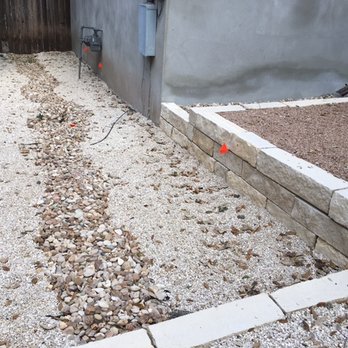 Austin Drainage + Landscape Development - 3/8" limestone rock, Colorado River Rock dry creek for drainage, limestone retaining wall - Landscaping Near Me - Austin, Texas