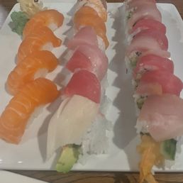 Sake nigiri, rainbow roll, 007 roll (left to right) Sake nigiri, rainbow roll, 007 roll (left to right)