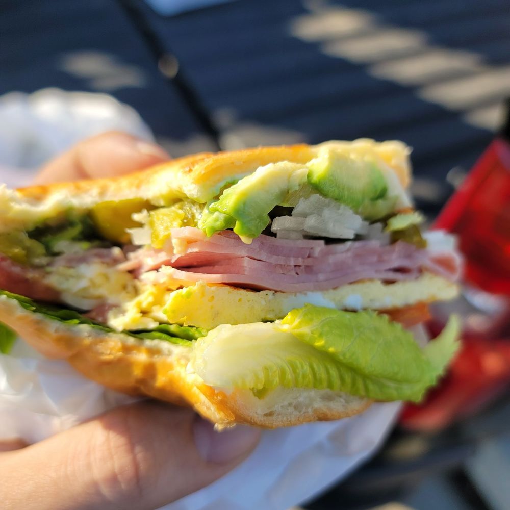 a person holding a sandwich a person holding a sandwich