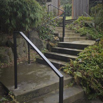 Athena Iron Works - Backyard Iron Railings. Modern, sleek design. Powder Coated black, core drilled and poured into place - Metal Fabricators Near Me - Maple Valley, Washington Athena Iron Works - Backyard Iron Railings. Modern, sleek design. Powder Coated black, core drilled and poured into place - Metal Fabricators Near Me - Maple Valley, Washington