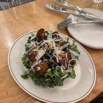 Taverne Atlantic - a plate of salad and a glass of water - Cocktail Bars Near Me - Montreal, Quebec