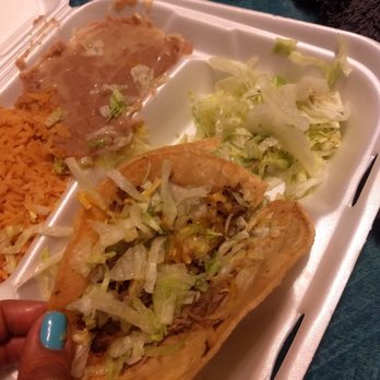 Beto's Tacos - a woman's hand reaching for a taco - Mexican Near Me - Citrus Heights, California