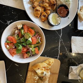 Cuisine 76 and Bar - Mediterranean mixed grill with chicken, Greek salad, and half eaten khachapuri - Mediterranean Near Me - Jacksonville, Florida