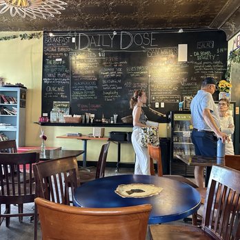 A Daily Dose - Inside/Menu - Inside A Daily Dose cafe, with a chalkboard menu on the wall, wooden tables and chairs, and customers ordering at the counter. - Juice Bars & Smoothies Near Me - Crested Butte, Colorado