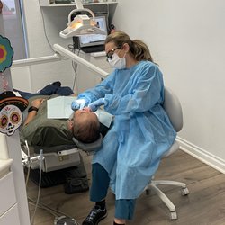 Our hygienist Olga making sure her patient leaves with  shiny clean teeth!