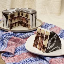 Homeboy Bakery - Homeboy Bakery's Tres Colores, signature cake. Marble cake topped with whip cream frosting and raspberry jam layers, with a chocolate shell.