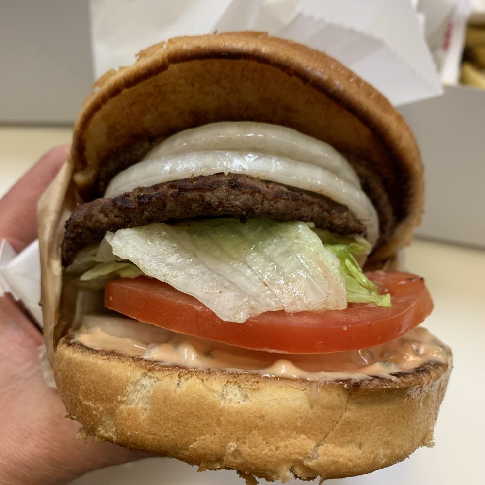 In-N-Out Burger - ows a hand holding a hamburger - Burgers Near Me - American Fork, Utah In-N-Out Burger - ows a hand holding a hamburger - Burgers Near Me - American Fork, Utah