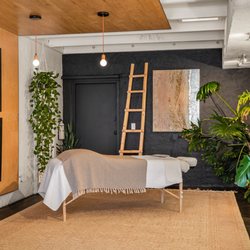 Anne’s Hands Massage Therapy - A calming massage room setup at Anne's Hands, featuring a comfortable massage table, soft lighting, and natural decor to enhance relaxation.
