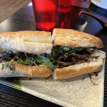 Pho 45 - a beef sandwich on a plate with chopsticks - Vietnamese Near Me - Lakeville, Minnesota Pho 45 - a beef sandwich on a plate with chopsticks - Vietnamese Near Me - Lakeville, Minnesota