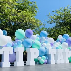 Bubbly balloons framing marquee letters.