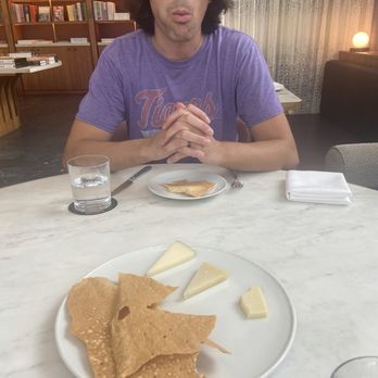 Lucian Books and Wine - Cheese Plate (featuring my husband taking a big bite) - Wine Bars Near Me - Atlanta, Georgia Lucian Books and Wine - Cheese Plate (featuring my husband taking a big bite) - Wine Bars Near Me - Atlanta, Georgia