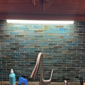 Antonio Tile - a kitchen sink with a faucet and soap dispenser - Flooring Near Me