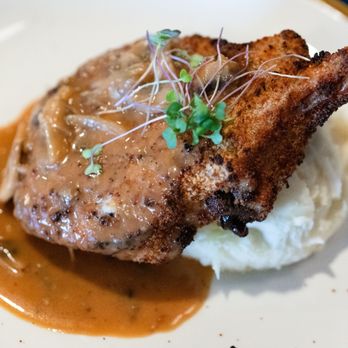 The Feast Restaurant - Patuxent Farms Pork Chop: 10oz Bone-in, Brined, Breadcrumbs, Mushrooms, Marsala Sauce - Seafood Near Me - Holmes Beach, Florida