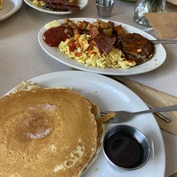 Home fries, eggs, sausage, bacon, pancakes