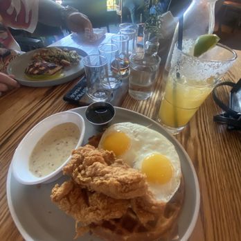 Whiskey Cake Kitchen & Bar - Chicken and waffles (me) and salmon (Philip). - New American Near Me - Katy, Texas Whiskey Cake Kitchen & Bar - Chicken and waffles (me) and salmon (Philip). - New American Near Me - Katy, Texas