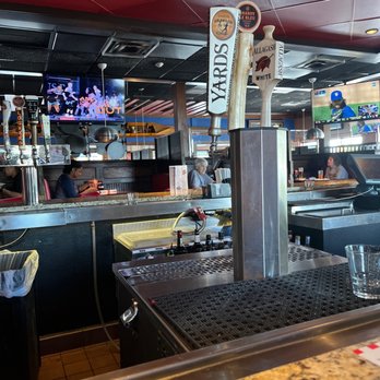 TGI Fridays - a view of a bar with a television in the background - American Near Me - Quakertown, Pennsylvania TGI Fridays - a view of a bar with a television in the background - American Near Me - Quakertown, Pennsylvania