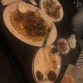 Al-basha - Appetizer sampler with hummus falafel and grape leaves to the right and entree of chicken Shish tawook over rice with salad to the left. - Hookah Bars Near Me - Charlotte, North Carolina