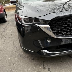 Crystal Mazda - Brand new car with a hole in the bumper