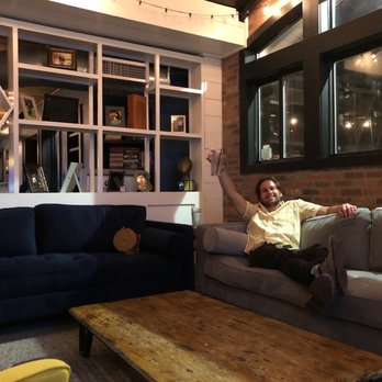 Marquis II - a man sitting on a couch in a living room - Bars Near Me - Houston, Texas Marquis II - a man sitting on a couch in a living room - Bars Near Me - Houston, Texas
