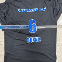 All Out Graphics - Number is not centered on back of shirt. Letters scrunched up and then shirt is pinched.