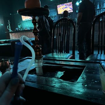 Darband Bar & Lounge - a person holding a toothbrush - Lounges Near Me - Austin, Texas