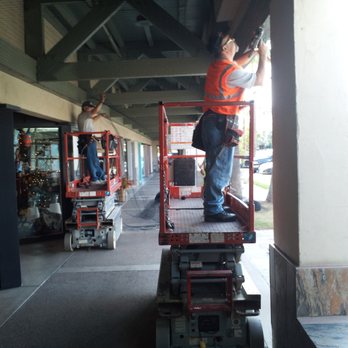 Rid A Bird Pest and Termite Control - Crew working on putting netting up in a shopping plaza to keep birds from nesting. - Pest Control Near Me - Phoenix, Arizona Rid A Bird Pest and Termite Control - Crew working on putting netting up in a shopping plaza to keep birds from nesting. - Pest Control Near Me - Phoenix, Arizona