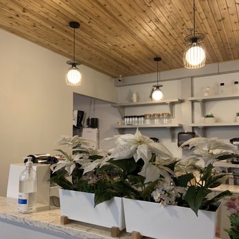 Ding Tea - a kitchen with white flowers and a counter - Bubble Tea Near Me - Vancouver, British Columbia