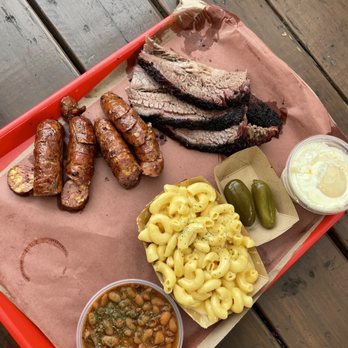 Terry Black's Barbecue - Sausage with jalapeño cheese, brisket, Mac n' cheese, pickled jalapeños, baked beans, banana pudding - Barbeque Near Me - Austin, Texas Terry Black's Barbecue - Sausage with jalapeño cheese, brisket, Mac n' cheese, pickled jalapeños, baked beans, banana pudding - Barbeque Near Me - Austin, Texas