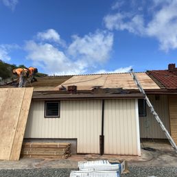 Tiles are placed around the roof to even out weight load on it. CDX plywood is being installed. Tiles are placed around the roof to even out weight load on it. CDX plywood is being installed.