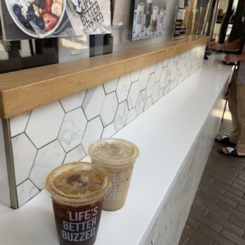 Better Buzz Coffee Fashion Valley - Front: killer bee iced & Back: honey lavender latte iced - Coffee & Tea Near Me - San Diego, California Better Buzz Coffee Fashion Valley - Front: killer bee iced & Back: honey lavender latte iced - Coffee & Tea Near Me - San Diego, California