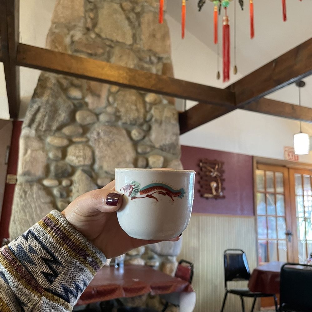 Lee's Kitchen - a person holding a coffee cup - Chinese Near Me - Prudenville, Michigan