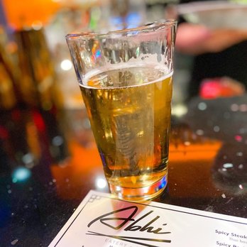 Abhi - a glass of beer on a table - Sushi Bars Near Me - Mountain Brook, Alabama